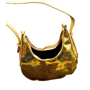 Saddle style adjustable straps golden handbag only used once excellent condition